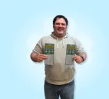 Winner Anthony V. holds two scratchcards in his hands